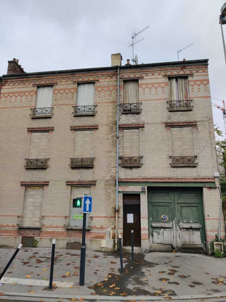 The windows of this derelict building are sealed with stones.