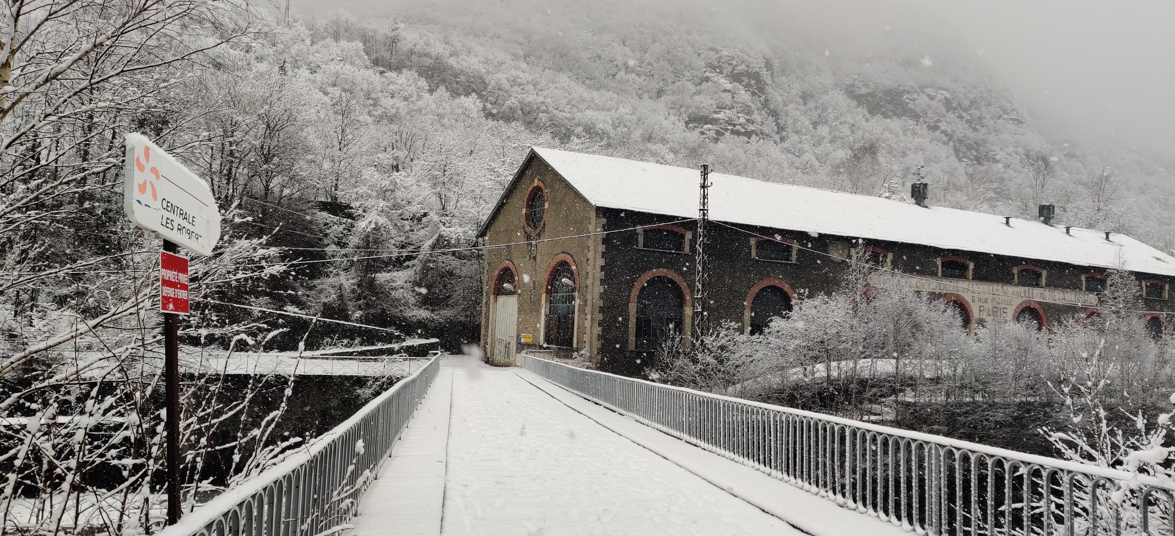 Urbex Frankreich Industriekultur Oisans, Historische Zentrale "Les Roberts", Wasserkraftwerk, EDF, Gebirgsfluss Romanche, Winter, Schnee, schneebedeckte Brücke, Schneeflocken fallen ins Bild, Französische Alpen, Urban Exploration