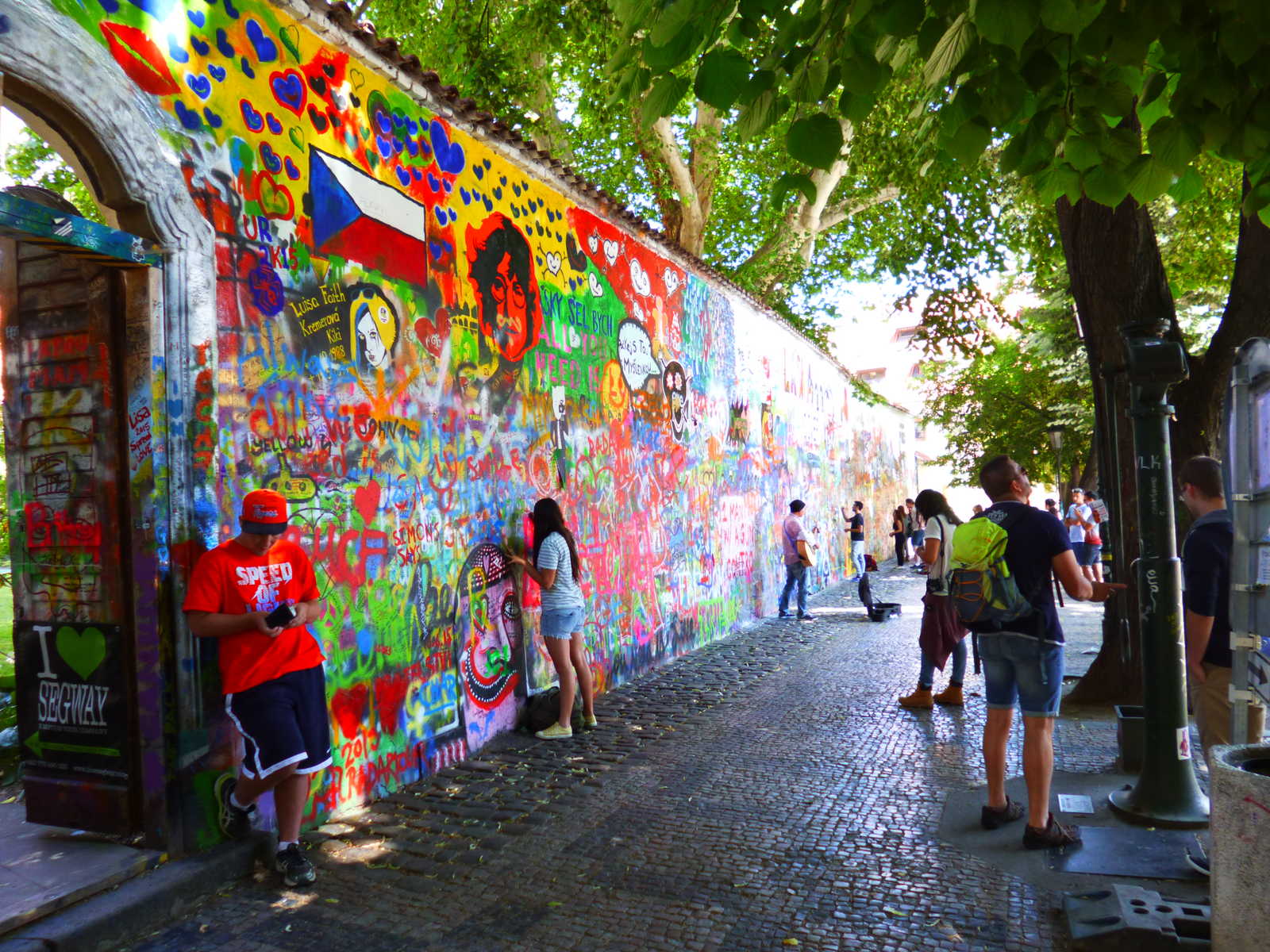 John Lennon Wall with tourists in the Old Town of Prague.